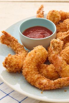 fried shrimp rings on a plate with dipping sauce