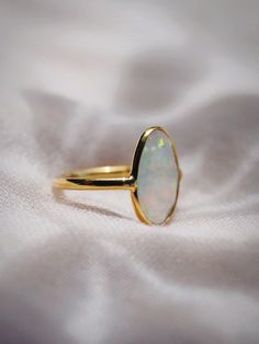 This bold gold statement ring features organic shaped Fire Opal that shines from within. This gorgeous gold ring is sure to become an everyday staple. Wear it solo or stack it with our other favorite rings.✦ DETAILS ✦✧ Name: Hinuhinu (HEE noo HEE noo) - bright, glittering, splendid.✧ Available in whole sizes 5-9. ✧ Synthetic Fire Opal Stone.✧ 18kt Gold Vermeil.✧ All Ke Aloha Jewelry pieces come packaged thoughtfully, beautifully, and ready for gift giving. Hawaii Jewelry, Fire Opal Ring, Gold Statement Ring, Cuff Rings, Gold Band Ring, Opal Stone, Cz Ring, Opal Ring, Favorite Rings