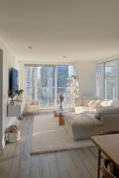 a living room filled with furniture and large windows