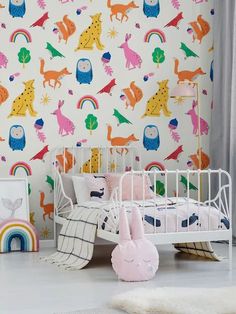 a child's bedroom with colorful wallpaper and bedding