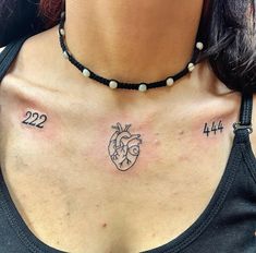 a woman with a heart tattoo on her chest