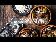 three bowls filled with different types of food on top of a wooden table next to utensils