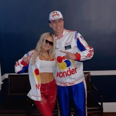 a man and woman dressed up in racing outfits