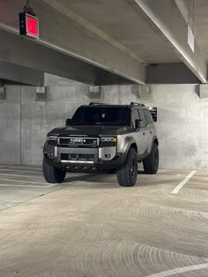 an suv is parked in a parking garage