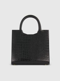 Exuding timeless elegance with a stylish flare, our Crocodile Leather Tote Bag is the perfect blend of sophistication and functionality. Its sleek design is complemented by multiple pockets, providing ample space for all your essentials. Mac Duggal Crocodile Embossed Leather Construction Croc-embossed and 24k Gold-plated hardware Two interior pockets Chic top handle with 22" in detachable strap for shoulder or crossbody wear Zipper closure Medium size: H 10.6 in x W 13.7 in x D 4.7 in (metric: 2 Classic Formal Shoulder Bag With Crocodile Pattern, Classic Crocodile Pattern Shoulder Bag For Formal Occasions, Chic Workwear Bags With Crocodile Pattern, Workwear Crocodile Pattern Top Handle Shoulder Bag, Evening Leather Bag With Crocodile Pattern, Classic Satchel With Crocodile Pattern For Everyday Use, Classic Everyday Satchel With Crocodile Pattern, Black Crocodile Pattern Bag For Work, Chic Crocodile Pattern Shoulder Bag For Work