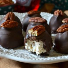 several pieces of chocolate with pecans on top