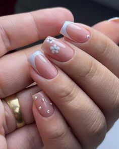 a woman's hand with french manies and flowers on it