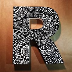 the letter r is decorated with black and white designs