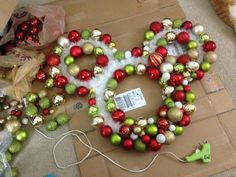 a cat laying on the floor next to christmas decorations