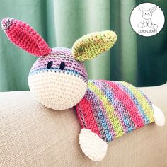 a crocheted stuffed animal laying on top of a couch