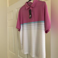 a pink and white shirt hanging on a door