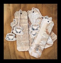 four tags with coffee cups on them sitting on top of a bed next to each other