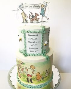 a three tiered cake with winnie the pooh characters on it and an inscription that says, sometimes the smallest things make up the most wonderful heart