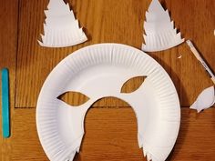 a paper plate with a mask cut out on it