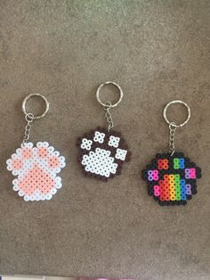 three key chains with different designs on them