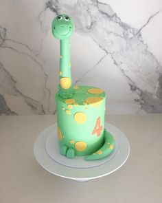 a green cake with a giraffe design on it