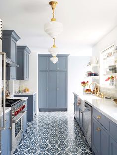 a kitchen with blue cabinets and white counter tops on instagramting from the facebook page