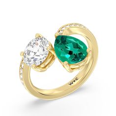 An absolute stunner, this two-stone ring with a beautifully curved band makes an excellent choice to pledge your love and commitment. Its polished shank features diamond-traced shoulders with ends that don't meet. One end slightly curves and holds a 1.75 ct round diamond while the other end curves more dramatically, securing a 2.50 ct pear-cut Created Emerald. Modern Emerald Ring For Anniversary, Modern Emerald Anniversary Ring, Anniversary Emerald Ring With Vs Clarity, Emerald Wedding Ring With Vs Clarity, Elegant Emerald Ring With Vs Clarity For Promise, Round Diamond Engagement Ring, Gorgeous Engagement Ring, Round Diamond Engagement Rings, Now And Forever