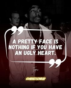 a man standing in front of a sign that says, a pretty face is nothing if you have an ugly heart