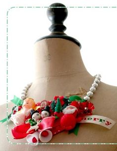 a mannequin is decorated with christmas decorations and beads on it's neck