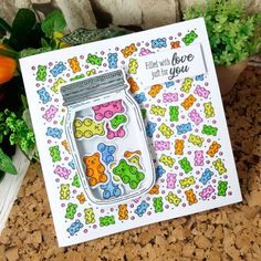 a card with colorful bears in a mason jar