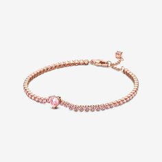 Bring elegance to your outfit with the Sparkling Pavé Tennis Bracelet. Hand-finished in our 14k rose gold-plated unique metal blend, this tennis bracelet is decorated with sparkling orchid pink man-made crystals. A large central heart-shaped stone punctuates a row of evenly sized pavé. The bracelet includes a lobster clasp for safe closure and can be adjusted to three lengths. Style it with other shimmering Pandora Timeless pieces for a classic look that stands out. Pandora Sparkling Heart Tenni Heart Tennis Bracelet, Pandora Armband, Bracelet Tennis, Bracelet Pandora, Gold Plated Bracelets, Pandora Bracelets, Pink Bracelet, Pandora Bracelet, Metal Bracelets