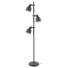 three light floor lamp with black metal base and white lamps on each side, in front of a white background