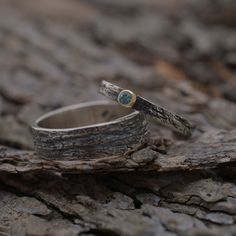 Unique set of two matching wedding rings inspired by the tree bark of an old olive family tree. Mixed precious metal rings made from sterling silver (men's band) and sterling silver and gold 14KT (women's band). On the top of womens band a natural gemstome of your choice is nested in 14KT gold. Custom made to your finger sizes. The price is for the set (two rings, one for the bride and one for the groom). The width of the men's band is 6mm and 2.5mm for the women's.Extremely strong and durable. Nature-inspired Hammered Jewelry For Anniversary, Nature-inspired Anniversary Rings With Polished Finish, Anniversary Nature-inspired Rings With Polished Finish, Nature-inspired Polished Jewelry For Anniversary, Nature-inspired Stackable Jewelry For Anniversary, Nature-inspired Stackable Jewelry For Anniversaries, Matching Wedding Rings, Wedding Band Sets, Tree Bark