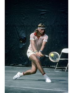 a man hitting a tennis ball with a racquet