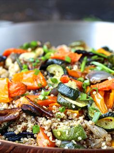 a bowl filled with rice and vegetables on top of a table