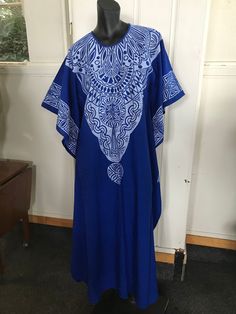 "A screen printed caftan tailored bu Indian Tailors in Fiji prior to 1972.Blue with white overprint which include Pacifica motifs.It is unworn. Fabulous symmetrical graphics which include a reference to Fiji Islands, It's label size is 32 which is to suit a 32\"bust. No faults. Still has original fold marks. These are the measurements, :- Bust 38\" Length from shoulder seam to hem 51\" Unstitched at sides for 21\" to allow ease of walking Overall width 38\" ( each side)" Traditional Pattern Maxi Kaftan For Festivals, Traditional Patterned Festival Maxi Kaftan, Traditional Pattern Maxi Length Kaftan For Festivals, Traditional Maxi Kaftan For Festivals, Long Bohemian Batik Print Dress, Spring Bohemian Kaftan With Batik Print, Printed Floor-length Maxi Dress For Festivals, Spring Bohemian Batik Print Kaftan, Bohemian Patterned Maxi Dress