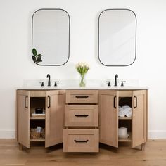 two mirrors are above the double sink vanity