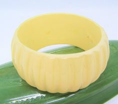 Amazing thick and wide white bangle is made of lucite and features ridges along the outside.  A perfect bangle to wear with everything bangle.   Size:  width - 1 1/2 inches             diameter - 2 1/2 inches             inside circumferance - 7 1/2 inches              fits an average size wrist Condition: vintage excellent - no chips, cracks or damage For other vintage jewelry, please visit my shop: https://www.etsy.com/shop/VintagObsessions Scarab Bracelet, White Birthday, Vintage Bangles, Bangles Bracelets, Gold Box, Crackle Glass, Statement Bracelet, Sterling Silver Cuff, Wood Earrings