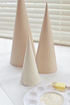 three cones sitting on top of a white table