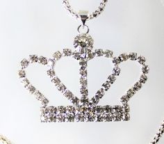 Gold or Silver Jewel Encrusted Crown Pendant, These crown necklaces are perfect for all royalty with all their rhinestones. They would make an exceptional gift for a fashionista. They are exquisite and would make an excellent charm or just as a collectible for the designer at heart. The are about 1.5 in x 2 in and they come with a 28" chain. Dazzling Crystal Rhinestone Necklaces For Gifts, Costume Jewelry With Rhinestones For Gifts, Party Pendant Rhinestone Necklace With Bling, Party Rhinestone Pendant Necklace With Bling, Metal Rhinestone Pendant Necklace, Crystal Rhinestones Necklaces For Gift, Crystal Rhinestone Necklace For Gift, Crystal Necklaces With Rhinestones For Gift, Crystal Necklaces With Rhinestones As Gift