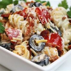 a white bowl filled with pasta and vegetables