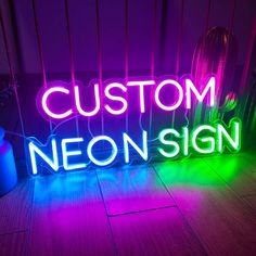 a neon sign sitting on top of a wooden floor