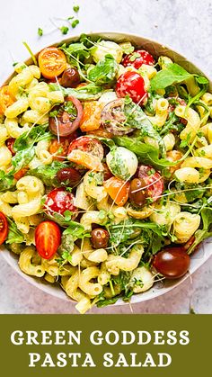 a bowl filled with pasta and vegetables on top of a table