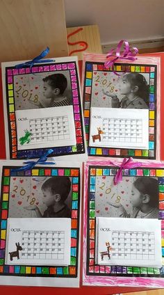 three calendars with pictures of children on them and ribbons tied around them, sitting on top of a table