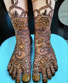 two feet with henna tattoos on them