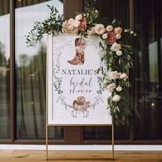 a sign that says natalie's bridal shower with flowers and leaves around it