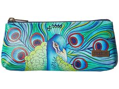 a blue and green purse with a large peacock on it's front side, sitting in front of a white background