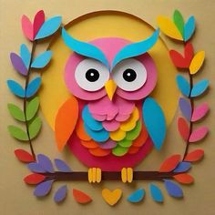 colorful paper cut out of an owl sitting on a branch