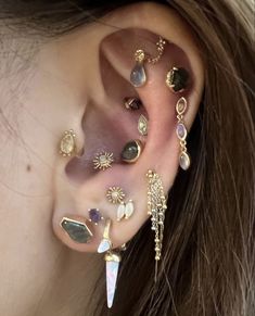 an ear with many different types of piercings on it