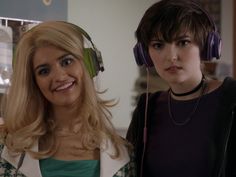 two women with headphones on standing next to each other