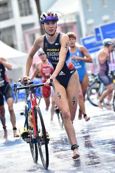 a group of bicyclists racing in the water