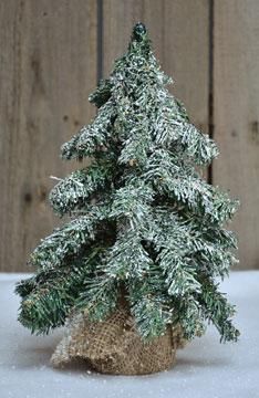 a small christmas tree sitting in the snow