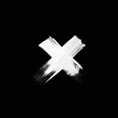 a white cross painted on the side of a black wall