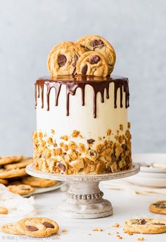 chocolate chip cookie cake with white frosting and cookies on top