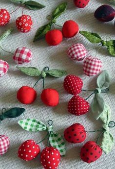 the fabric is covered with cherries and green leafy stems, which are decorated with polka dots